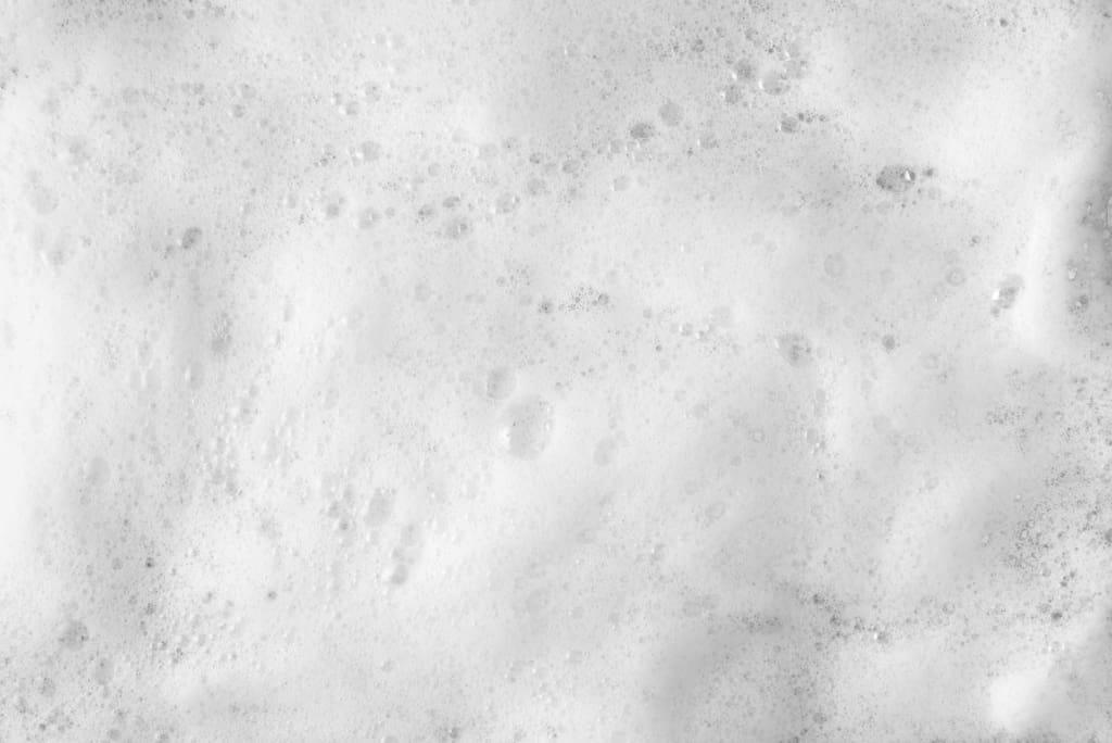 Foam formation due to air entrainment during powder mixing in confectionery production